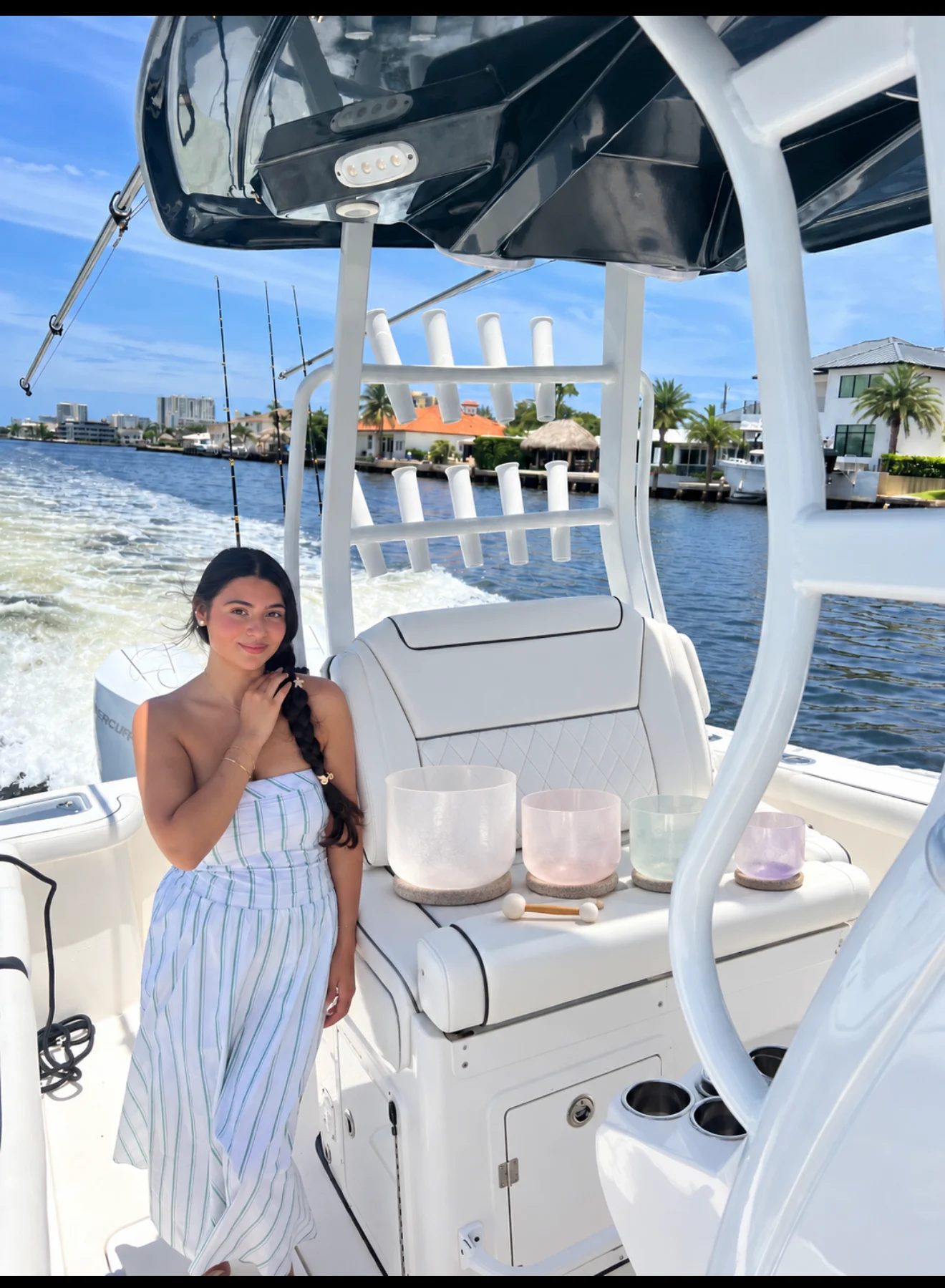 Sylvia Lee seated aboard the white boat beside the Florida waterfront